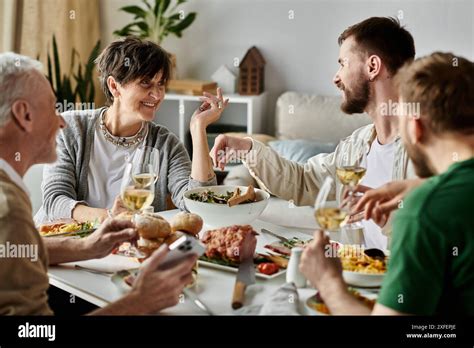 A Gay Couple Shares A Meal With Parents At Home Stock Photo Alamy