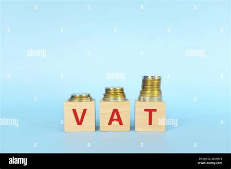 Vat Letters On Wooden Blocks In Blue Background Increasing Stack Of