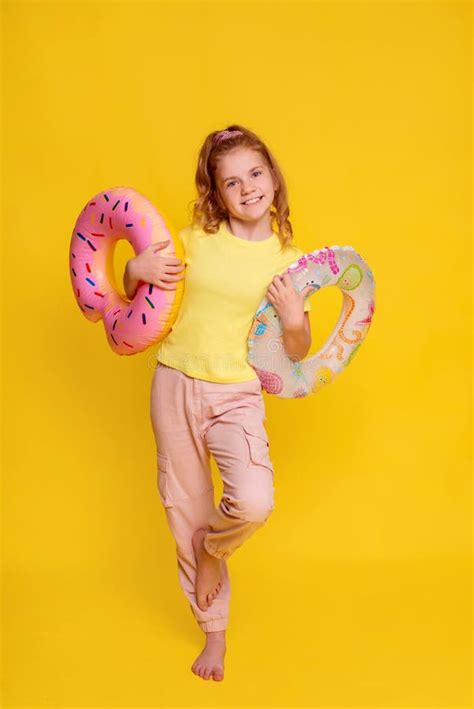 Sunny Preteen Girl In Yellow T Shirt Mock Up On Yellow Background Girl Puts On Or Takes Off