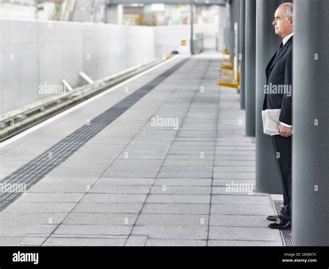 Mature Businessman Waiting At Train Station Stock Photo Alamy