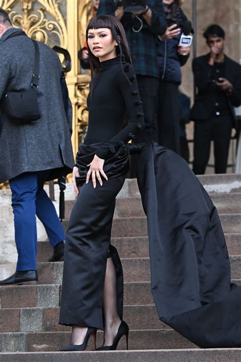 Zendaya Arrives At Fendis Paris Show In A Plum Gown And Micro Bangs