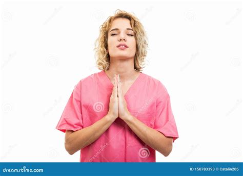 Portrait Of Nurse Wearing Pink Scrub Making Prayer Gesture Stock Image