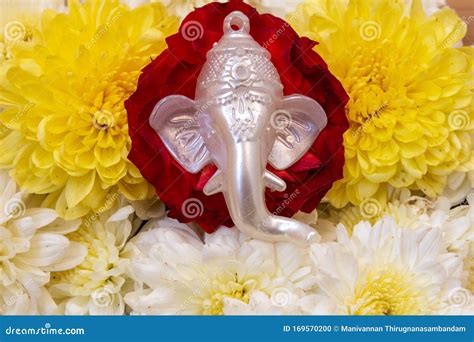 Face Of Lord Ganesha Placed Over Beautiful Rose And Chrysanthemum