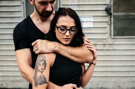 Guy Hugging His Girlfriend From Behind Stock Image Colourbox