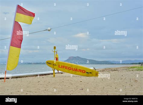 Surf Life Saving Flags And Paddle Board At A Stinger Net Pallarenda