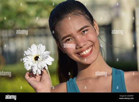 An Attractive Female Smiling With Flowers Stock Photo - Alamy