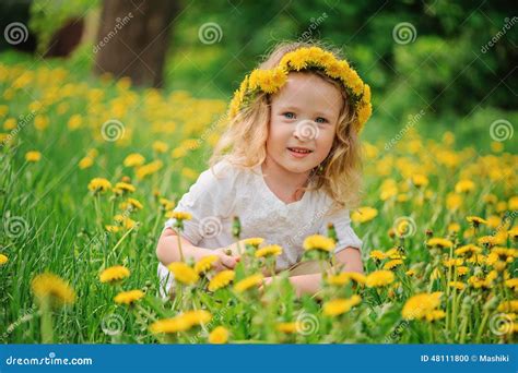 Smiling Child Girl In Dandelion Wreath On Spring Flower Field Stock