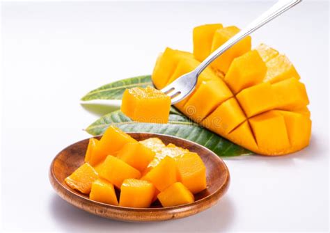 Fresh And Beautiful Mango In A Wooden Plate With Sliced Diced Mango