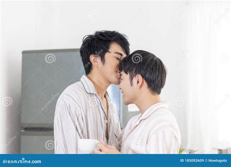 Asian Gay Couple Homosexual Cooking Together In The Kitchen Prepare Fresh Vegetable Make Organic