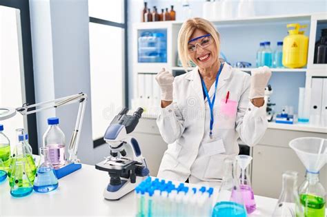 Middle Age Blonde Woman Working At Scientist Laboratory Very Happy And