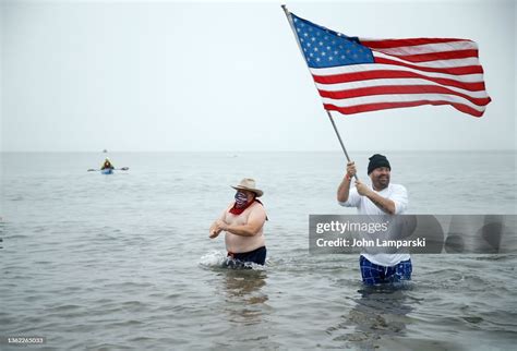 People Participate In A New Years Day Polar Bear Plunge Into The