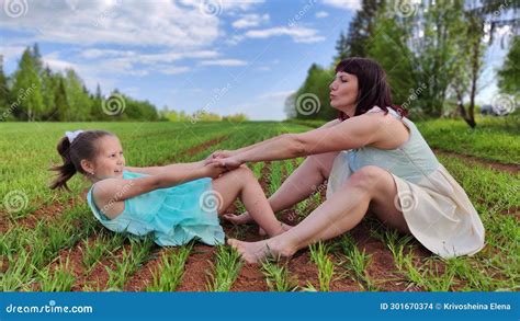 Happy Mother And Daughter Enjoying Rest Playing And Fun On Nature In