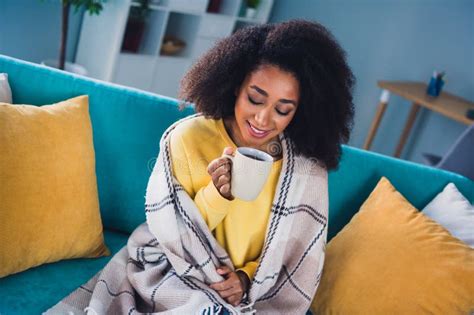 Photo Of Adorable Cute Girl Sitting On Sofa Drinking Hot Tea Enjoying Vacation Cozy Atmosphere