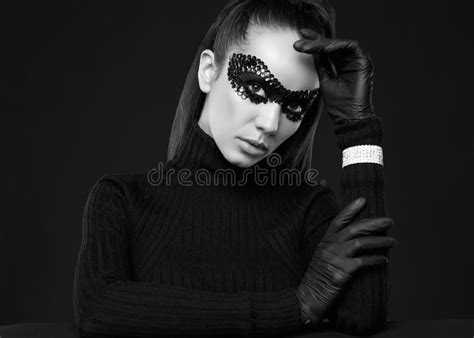 Elegant Brunette Woman In Sequins Mask Posing On A Mirrored Surface