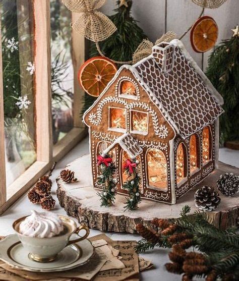 A Gingerbread House Is On A Table Next To Some Christmas Decorations