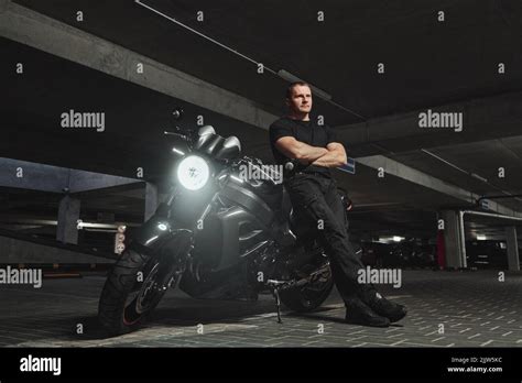 A Man And Motorcycle In Underground Parking Garage Stock Photo Alamy