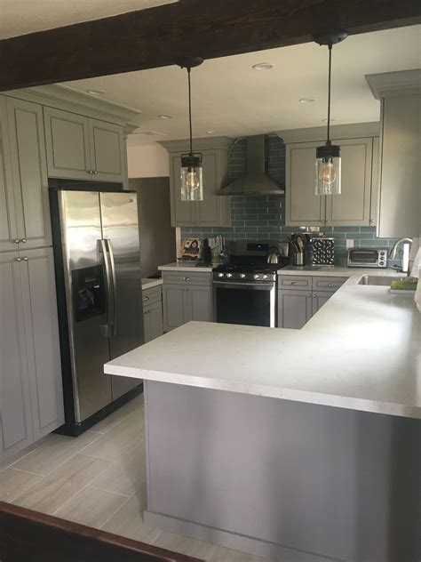 Open Kitchen Concept With Gray Cabinets White Quartz Countertops Blue