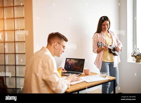 Smiling Awesome Talented Brunette Girl Is Disturbing Her Boyfriend Who Is Preparing For Exams