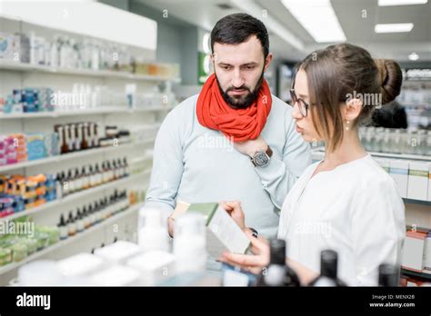 Pharmacist With Client In The Pharmacy Store Stock Photo Alamy