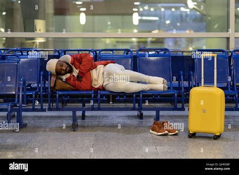 Black Guy Lying On Chairs In Airport Lounge Can Not Sleep On An