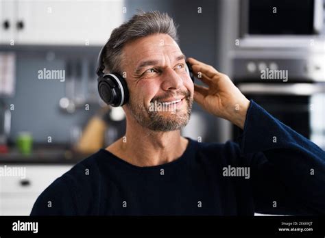 Smiling Older Mature Man Listening Music On Headphones Stock Photo Alamy