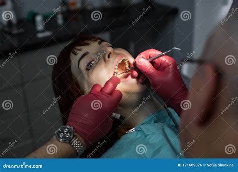 Beautiful Young Woman With Open Mouth At Dentist Having Dental