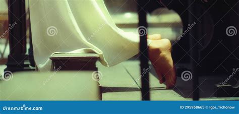 Barefoot Girl In A Long Dress Praying On Her Knees In Church Close Up