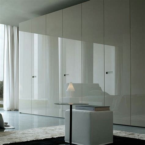 Wall to wall storage in high gloss cabinet fronts. Would prefer discreet handles or sliding door ...