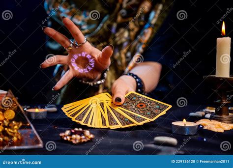 The Fortune Teller Holds A Fan Of Cards In Her Hands And Casts A Spell