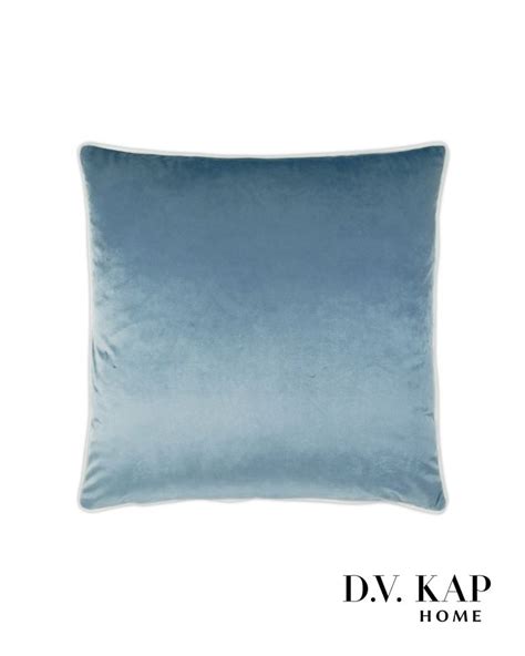 A Blue Velvet Pillow On A White Background With The Words D V Kap Home