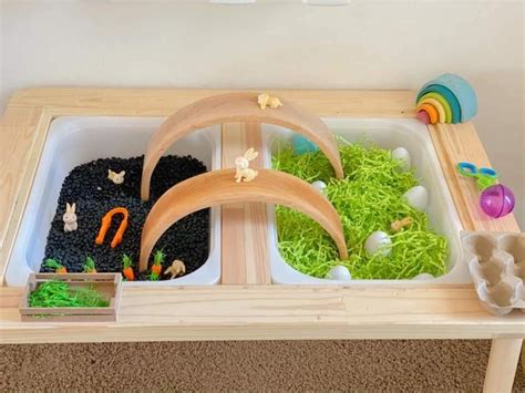 A Wooden Table With Two Trays Filled With Different Types Of Plants And