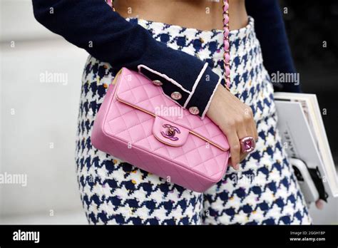 Guest wearing a 2.55 pink Chanel bag - Streetyle at Paris Fashion Week High Fashion - Paris ...