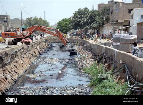 Heavy Machinery Busy In Cleaning The Main Sewerage Drain During A