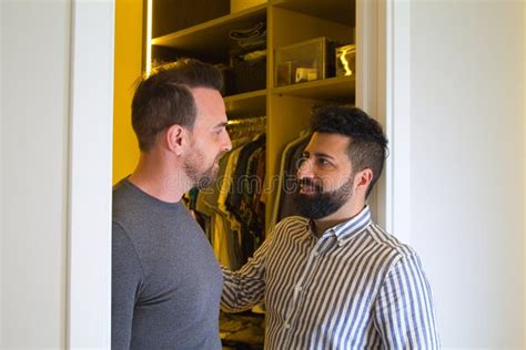Gay Couple At The Entrance Of The Dressing Room After Changing Clothes