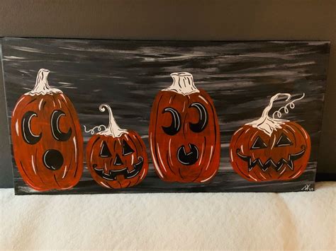 three carved pumpkins sitting on top of a table