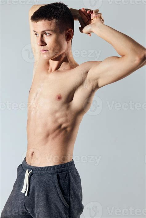 Handsome Athlete With Inflated Torso Holds His Hands Behind His Head