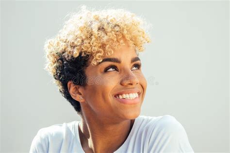 Hispanic Latin Woman With Afro Blonde Haircut Dressed In White Top