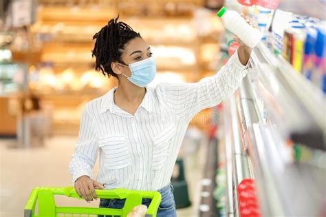 Black Woman Wearing Face Mask Shopping Grocery In Supermarket Stock