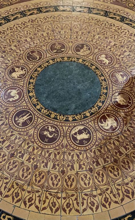 an intricately designed floor in the middle of a building with circular ...