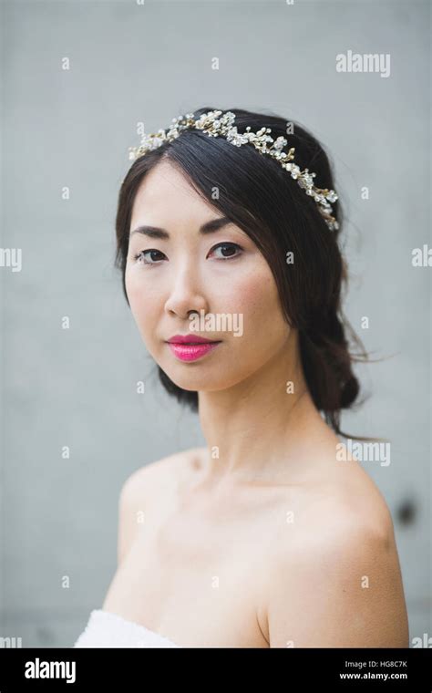 Portrait Of Woman Wearing Tiara While Standing Against White Wall Stock