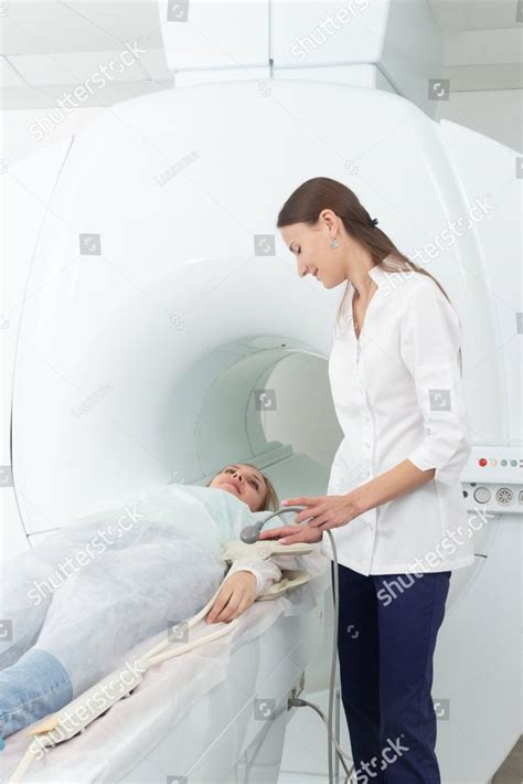 Radiologic Technician And Woman Patient Lying On A Ct Scan Bed