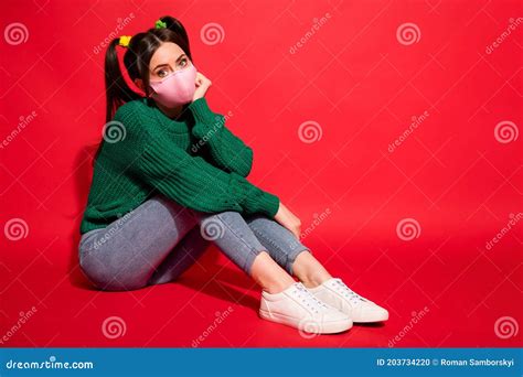 Photo Of Masked Pretty Young Woman Sit Floor Hold Hand Cheek Sit Wear