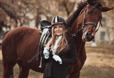 Professional Horsewomanprofessional Equestrienne Stand Near The Brown