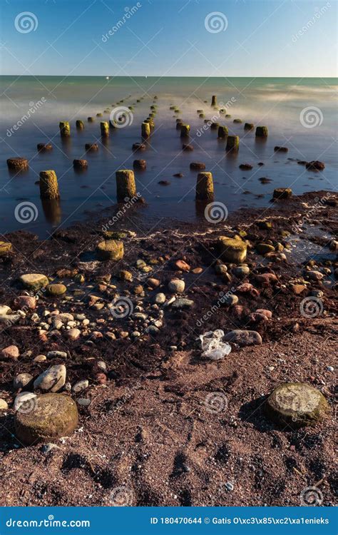 Old Boat Mooring Poles On The Shores Of The Baltic Sea Stock Photo