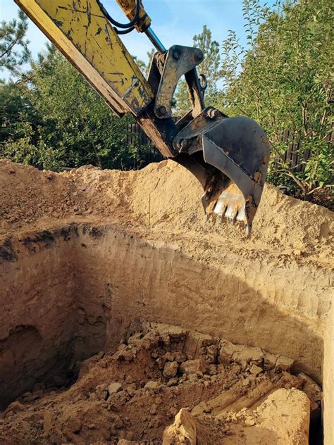 Digging The Pit Foundation A Hole With Excavator At The Construction