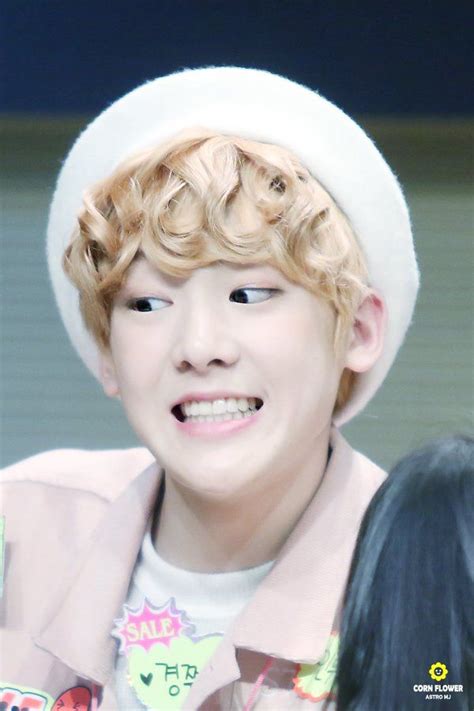 A Boy With Curly Hair Wearing A White Hat