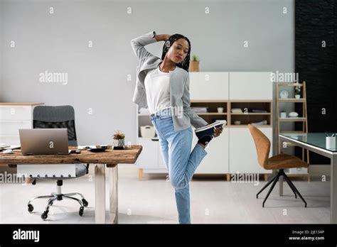 African Woman Doing Stretching Exercise At Office Desk Stock Photo Alamy