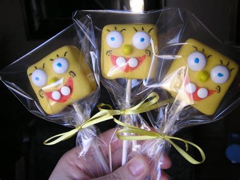 four lollipops in the shape of spongebob faces wrapped in cellophane