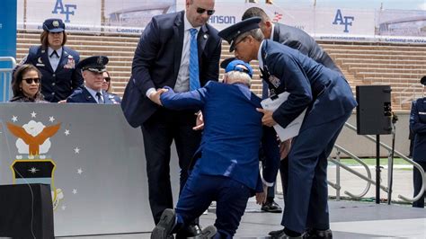 Us President Joe Biden Helped To His Feet After Tripping And Falling On