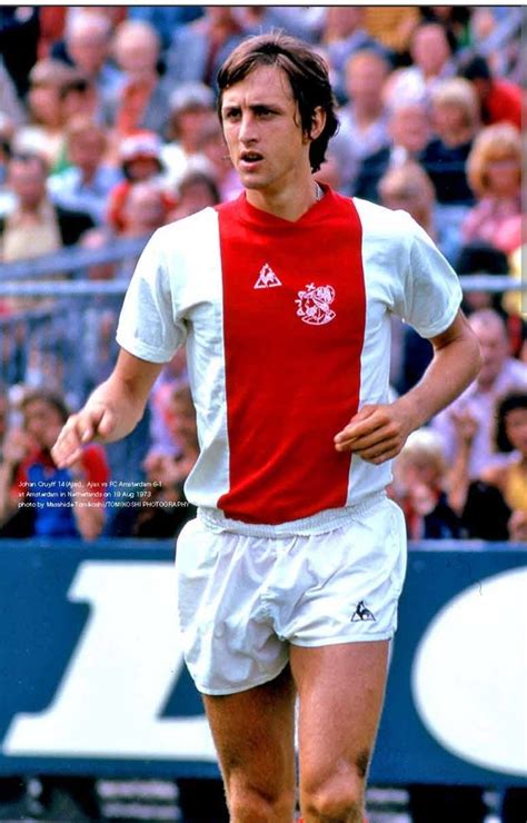 a man in red and white uniform running on a soccer field with ...